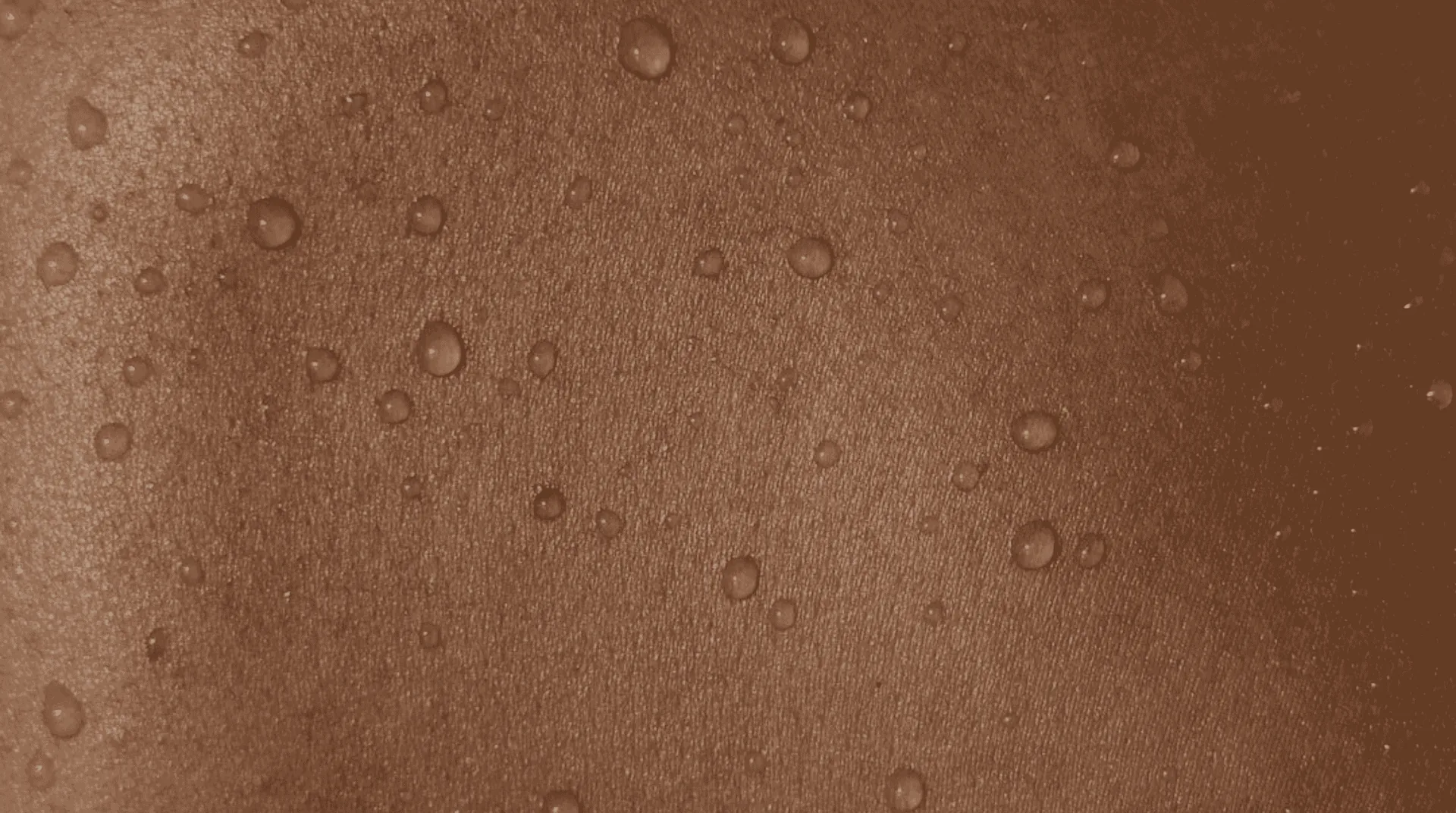 Macro close-up of calm, clear skin, the result of lowering stress and cortisol so your skincare can work